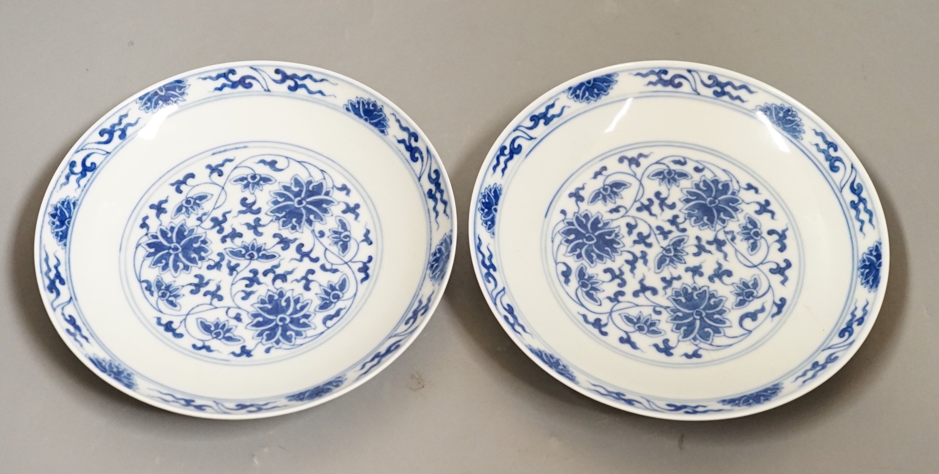 A pair of Chinese blue and 'white lotus' dishes, Qianlong marks, 16.5cms diameter